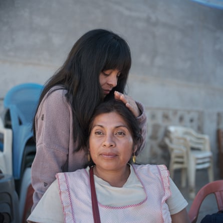 Mayrani Bautista, sister of disappeared student Benjamin, caresses their mother Cristina