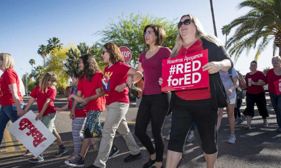 Teachers stage a ‘walk-in’’ demonstration before the school day begins at Pueblo elementary school in Arizona this week.