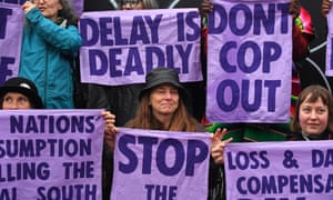 Members of climate action protest group Scientist Rebellion hold signs during a demonstration in Glasgow on the sidelines of the COP26 UN Climate Change Summit