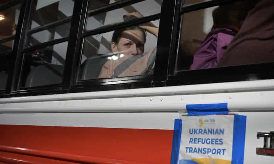 A Ukrainian woman looks from a bus at the San Ysidro Port of Entry in Tijuana, Mexico, which transports refugees from a shelter to the border where they hope to enter the United States