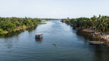 Yvette Yaa Konadu Tetteh, with her support boat, The Woman Who Does Not Fear, swimming down the River Volta in Ghana