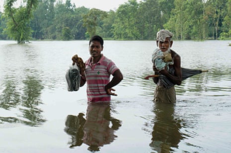 Men wade through floodwaters in Kurigram, northern Bangladesh