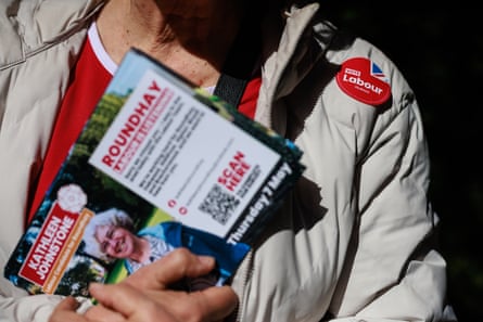 A close-up image of a woman holding information about local elections in Leeds in her hands