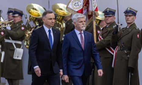 Polish President Andrzej Duda (L) reviews a military honour guard during a welcoming ceremony in front of the presidential palace in Warsaw, Poland, 16 March 2023. Poland’s president said Thursday that his country plans to give Ukraine around a dozen MiG-29 fighter jets.