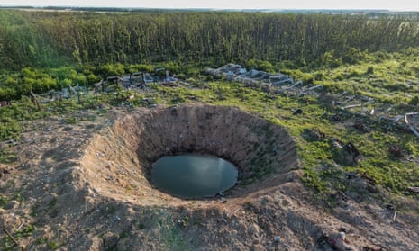 A big shelling crater in Dovhenke village, Kharkiv region