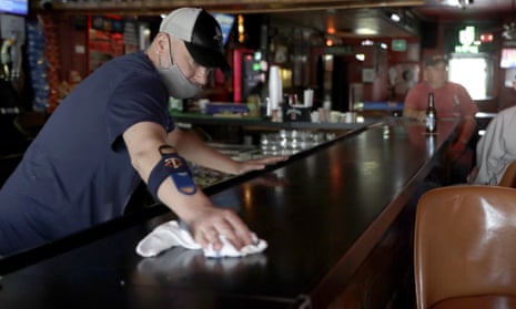 Greg Anderson wipes down the bar on the first day Tuner’s Bar and Grill has reopened after being closed in St Charles, Missouri.