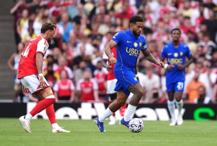 Reece James carries the ball forward, trying to avoid the attentions of Ben White
