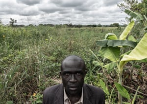 Man stands in overgrown field