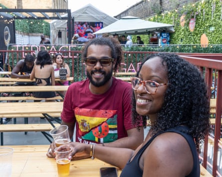Man and woman sat at a bench in a beer garden