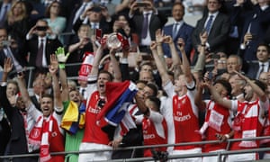 Laurent Koscielny and Per Mertesacker hoist the trophy high.