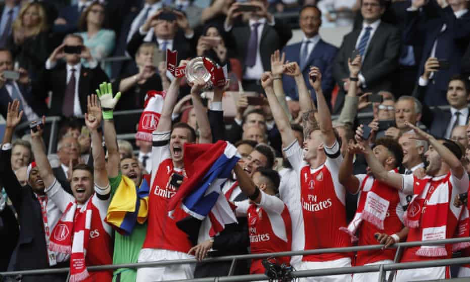 Laurent Koscielny and Per Mertesacker hoist the trophy high.