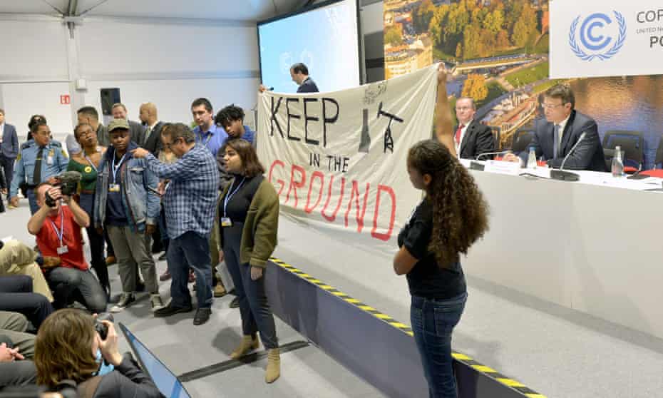 Patrick Suckling (sitting on panel right), Australia’s ambassador for the environment, waits as protesters disrupt an event at the COP24 climate change summit in Katowice, Poland