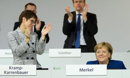 Annegret Kramp-Karrenbauer applauds Angela Merkel.