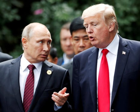 US President Donald Trump and Russia's President Vladimir Putin talk during the family photo session at the APEC Summit in Danang, Vietnam in 2017.