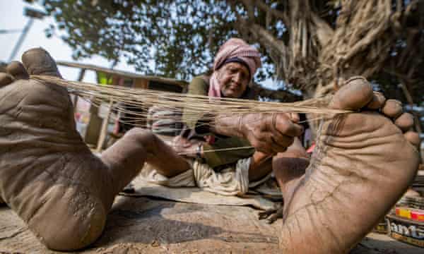 Zapatero, from the Chamar community, making thread to sew soles in Uttar Pradesh. A job in the civil service is a way out of extreme poverty for Dalits.