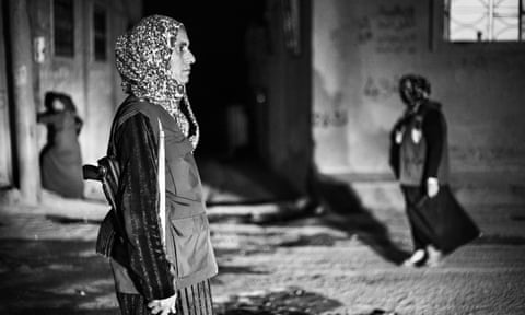 Members of the the self-organised social defence forces of Rojava on duty at night on the streets of Kobane.