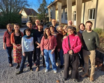 A group of people standing together outside a house