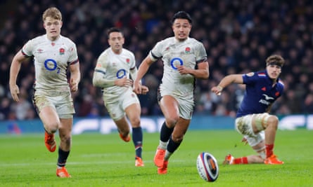 Fin Smith and Marcus Smith of England chase down the ball at Twickenham.