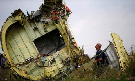 A Malaysian air crash investigator inspects the crash site of flight MH17
