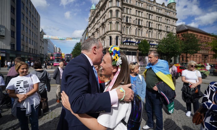 Conor Burns (left), Minister of State for Northern Ireland joins Ukrainians celebrating Ukraine independence Day, outside Belfast City Hall.