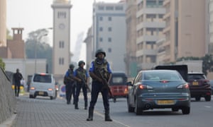 Sri Lankan military personnel stand guard on a main road near the president’s house in Colombo.