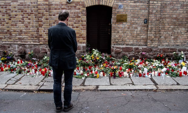 A man looks at tributes outside the synagogue in Halle, Germany