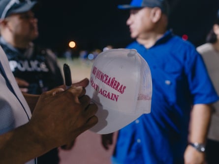 Man signs baseball hat