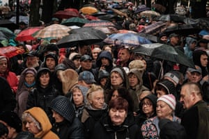 People wait for food items during a distribution by the local branch of Caritas Internationalis, a Catholic charity organisation, in Kharkiv, Ukraine