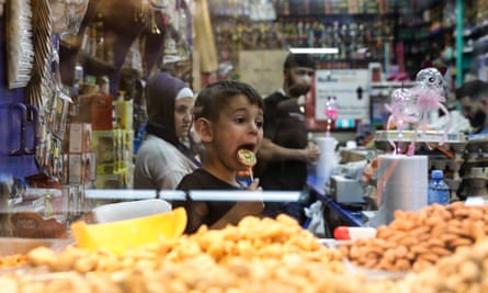 A young boy licks a lolly in a stall at the Ramadan night markets in Sydney suburb Lakemba.