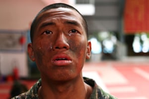 Wu Yu-wei, 26, cries as two fellow trainees leave the program
