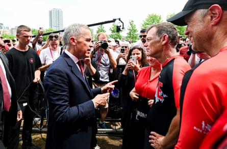 a man speaks to another man in a crowd