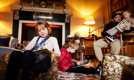 National Trust, çocukların Sudbury Hall'da özgürce dolaşmasına izin verdiği için ipler iniyor | Ulusal Güven 1 Kütüphanede kitap okuyan aileler