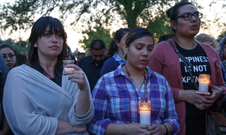 Attendees at a candlelight vigil at Our Lady of the Assumption church in San Bernardino, California, on Monday to mourn the victims of a deadly shooting at a local elementary school.