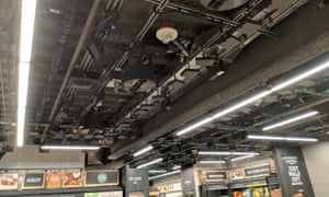 A bank of cameras and other sensors in the ceiling tracks shoppers through the store.