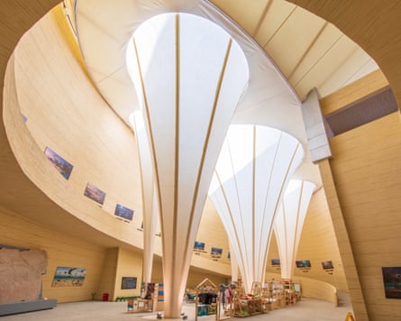 Photo of the light-filled atrium of the museum with large light funnels coming down from the surface