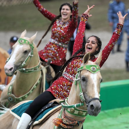 Riders in traditional dress perform stunts on horseback at the opening ceremony.