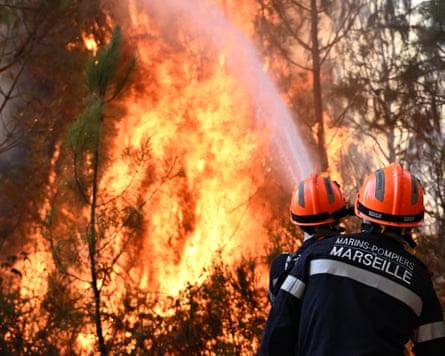 Firefighters use a water jet on a fire