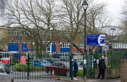 People near the gates of the school