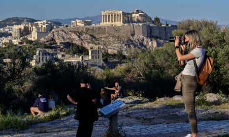 Tourists enjoy a view of the Acropolis.