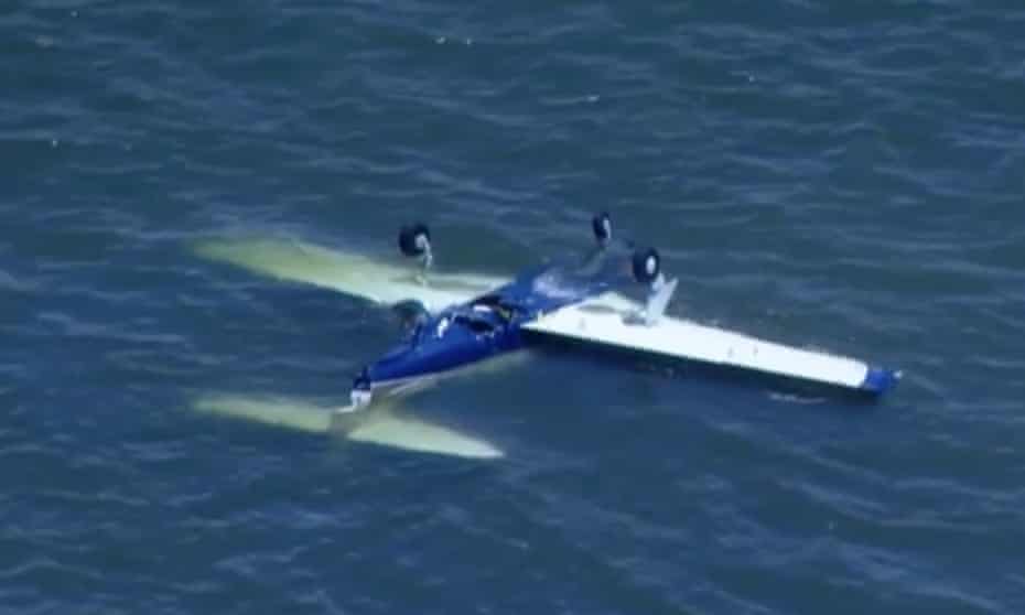 A screenshot obtained from a Nine News broadcast on Sunday, December 19, 2021, shows a light plane in water off the coast of Redcliffe, north-east of the Brisbane