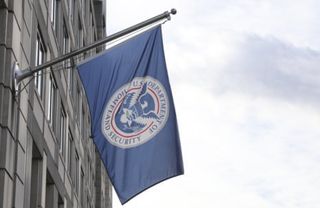 A Department of Homeland Security flag hangs from a pole outside a building in Washington DC.