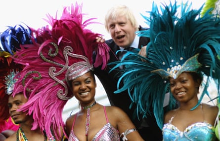 Boris Johnson when he was mayor of London with members of the carnival mas band Genesis.
