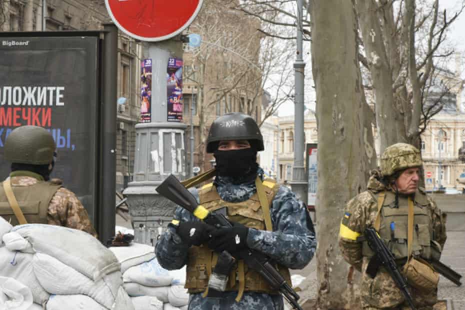 Armed men by sandbags