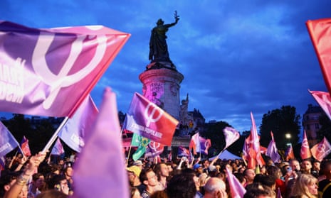 Demonstrators wave flags in support of the New Popular Front as they gather to protest against the French far-right at the Place de la Republique.
