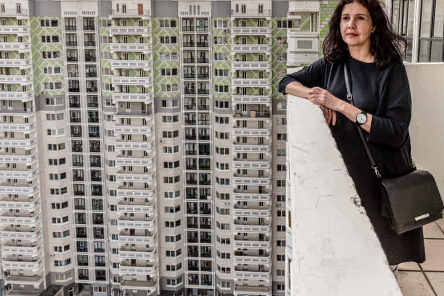 Vivian Del Rio, Photographer and Artist on the balcony of her new apartment block , built on the site of her old neighbourhood.