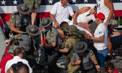 US-POLITICS-VOTE<br>A person is removed by state police from the stands after guns were fired at Republican candidate Donald Trump at a campaign event at Butler Farm Show Inc. in Butler, Pennsylvania, July 13, 2024. The suspected shooter who wounded Republican presidential candidate Donald Trump at a rally is dead, US media reported Saturday, along with one bystander. (Photo by Rebecca DROKE / AFP) (Photo by REBECCA DROKE/AFP via Getty Images)