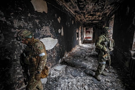 A picture taken during a visit to Mariupol organised by the Russian military shows a Russian serviceman securing the area inside the destroyed Drama Theatre in Mariupol, on 12 April 2022.