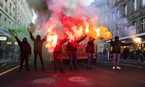 Protesters burn fireworks during a demonstration against the World Economic Forum in Bern, Switzerland