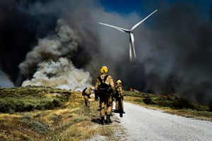 Firefighters work at a forest fire in Celorico da Beira, Guarda.