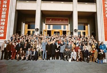 Ford and his secretary of state, Henry Kissinger, amid large crowd of people posing on steps